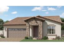 Charming single-story home featuring a desert landscape, a two-car garage and a stone entryway for added curb appeal at 17382 W Artemisa Ave, Surprise, AZ 85387