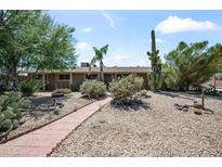 Charming single-story home featuring desert landscaping, a paved walkway, and a serene Southwest ambiance at 18212 N 43Rd Pl, Phoenix, AZ 85032