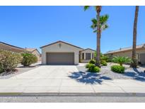 Charming single-story home with a low-maintenance landscaped front yard and a two-car garage at 18651 N Salerno Ct, Surprise, AZ 85387