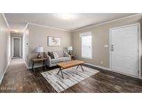 Cozy living room with modern furnishings, neutral color palette, and dark wood-look flooring at 320 E Mckellips Rd # 45, Mesa, AZ 85201