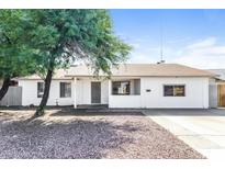 Charming single-story home featuring a well-maintained front yard and neutral color palette at 4833 N 63Rd Ln, Phoenix, AZ 85033