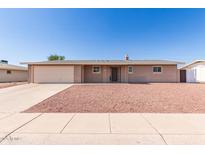 Charming single-story home with a spacious front yard and attached garage in a quiet neighborhood at 6022 E Colby St, Mesa, AZ 85205