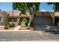 Charming single-story home with well-maintained landscaping and a spacious two-car garage at 64 N 63Rd N St # 33, Mesa, AZ 85205