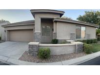 Inviting single-story home featuring stone accents, a two car garage, and desert landscaping at 7052 E Kessler Ave, Mesa, AZ 85209