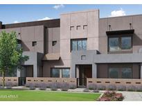 Modern townhome featuring clean lines, a neutral color palette, and a well-manicured lawn at 733 E Commonwealth Ave # 36, Chandler, AZ 85225