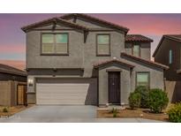 Charming two-story home featuring a two-car garage and neatly manicured landscaping at 7413 S 32Nd Dr, Phoenix, AZ 85041
