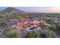 Charming desert home with a pool, spa, and lush backyard oasis nestled amidst the stunning mountain views at 8024 E Lone Mountain Rd, Scottsdale, AZ 85266