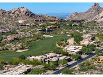 Scenic aerial view of homes in a golf community, with desert landscaping and mountain views at 10641 E Blue Sky Dr, Scottsdale, AZ 85262