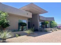 Contemporary home featuring modern architecture and desert landscaping at 10821 E Troon North Dr, Scottsdale, AZ 85262