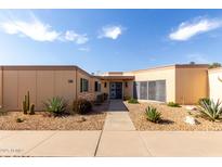 Charming single-story home featuring xeriscaped front yard and covered entryway at 13889 N 108Th Dr, Sun City, AZ 85351