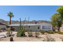 Charming single-story home featuring desert landscaping and a covered carport at 1413 E Dobbins Rd, Phoenix, AZ 85042