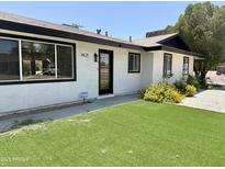 Charming home with well-manicured lawn, inviting curb appeal, and fresh exterior paint at 1421 W Pasadena Ave, Phoenix, AZ 85013