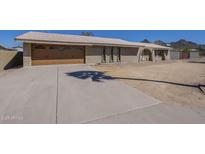 Charming single-story home featuring a tile roof, spacious driveway, and a two car garage at 1530 E Loma Ln, Phoenix, AZ 85020