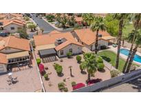 Aerial view of a Southwestern-style home with a refreshing pool and mature landscaping in a well-kept neighborhood at 1549 N La Rosa Dr, Tempe, AZ 85288