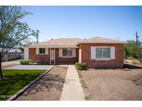 Charming brick home featuring updated landscaping and a well-manicured front yard at 1721 W Earll Dr, Phoenix, AZ 85015
