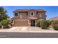 Charming two-story home with a two-car garage, desert landscaping, and a classic suburban appeal at 18182 W Desert Ln, Surprise, AZ 85388