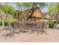 Inviting property entrance with stone signage and beautifully landscaped surroundings at 2150 E Bell Rd # 1088, Phoenix, AZ 85022