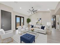 Bright living room boasts contemporary furnishings, neutral tones, and stylish decor for comfortable living at 25846 W Denver Hill Dr, Wittmann, AZ 85361