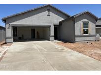 Newly built single-story home with a two-car garage and neutral colored stucco at 29679 N Oak Dr, Florence, AZ 85132