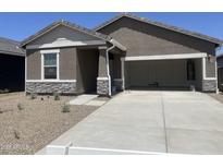 Charming single-story home featuring stone accents and an attached two-car garage at 29707 N Oak Dr, Florence, AZ 85132