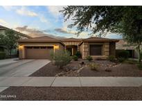 Charming single-story home with a well-manicured desert landscape and a three car garage at 3018 E Vernon St, Gilbert, AZ 85298