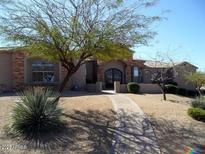 Inviting single-Gathering home showcasing desert landscaping, a paved walkway, and a decorative front door at 35401 N Via Tramonto St, Phoenix, AZ 85086