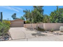 Charming single-story home with a desert-landscaped front yard, private wall, and a two-car garage at 7806 N Via Del Sol --, Scottsdale, AZ 85258