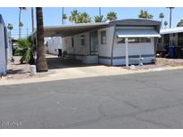 Charming single-story home with a covered carport and well-maintained landscaping at 7807 E Main St # D-26, Mesa, AZ 85207