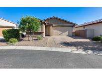 Charming single-story home featuring a two-car garage and a well-maintained desert landscape at 12211 W Hide Trl, Peoria, AZ 85383