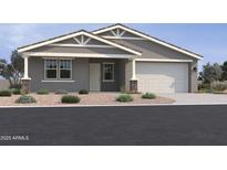Charming single-story home showcasing desert landscaping, a two-car garage, and inviting covered entryway at 15794 W Cheryl Dr, Waddell, AZ 85355