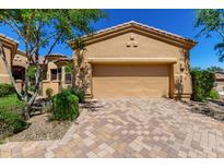 Exterior shot of a single-story home featuring a tan stucco garage, and a paver driveway at 16538 E Westwind Ct # 51, Fountain Hills, AZ 85268