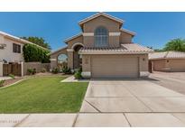 Beautiful two-story home with a spacious driveway, desert landscaping, and a tile roof at 1705 W Lark Dr, Chandler, AZ 85286