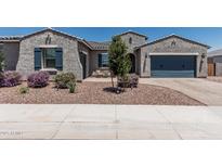 Charming single-story home featuring a stucco exterior, blue shutters, and desert landscaping at 17980 W Meadowbrook Ave, Goodyear, AZ 85395