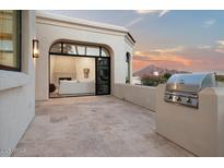 View of the mountain and patio with a stainless steel BBQ and outdoor access to a living room with a fireplace at 3800 E Lincoln Dr # 54, Phoenix, AZ 85018