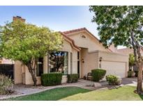 Charming single-story home features a well-manicured lawn, mature landscaping, and a cozy front porch at 3828 N Rosewood Ave, Avondale, AZ 85392