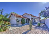 Charming single-story home featuring a low-maintenance yard, desert landscaping and a two-car garage at 522 W Dennis Ct, Tempe, AZ 85283