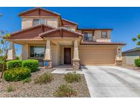 Charming two-story home with a well-maintained front yard, desert landscaping, and covered entrance at 5516 N 193Rd Ave, Litchfield Park, AZ 85340