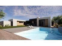 Inviting backyard pool with lounge chairs and a modern home exterior, perfect for relaxation and entertaining at 8528 E Clydesdale Trl, Scottsdale, AZ 85258