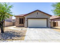 Charming single-story home featuring a two-car garage and stone veneer accents, creating an inviting curb appeal at 923 E Randy St, Avondale, AZ 85323
