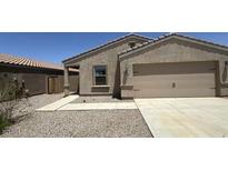 Charming single-story home featuring a two-car garage and low maintenance desert landscaping at 13142 E Aster Ln, Florence, AZ 85132