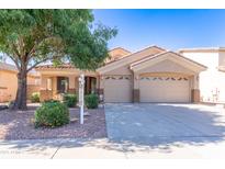 Charming home featuring desert landscaping, a two-car garage and beautiful curb appeal at 14436 W Ventura St, Surprise, AZ 85379