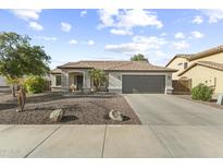 Charming single-story home with a two-car garage, neutral paint, and low-maintenance landscaping at 15969 W Adams St, Goodyear, AZ 85338