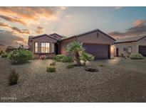 Charming single-story home features a two-car garage, desert landscaping, and tile roof at 16469 W Century Plant Dr, Surprise, AZ 85387