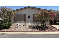Charming home exterior with lush landscaping and decorative yard art at 3330 E Main St # 448, Mesa, AZ 85213
