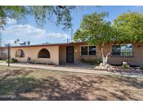 Charming single-story home featuring desert landscaping, brick accents and covered entry, set beneath a sunny sky at 6739 N 16Th St # 17, Phoenix, AZ 85016