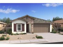 Charming one-story home featuring stone accents, a two-car garage, and desert landscaping at 7435 S 76Th Dr, Laveen, AZ 85339