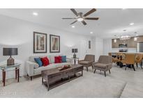 Bright living room featuring modern furnishings, a ceiling fan, and access to the dining area at 7777 E Main St # 215, Scottsdale, AZ 85251