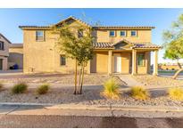 Charming two-story home featuring a welcoming front porch and low-maintenance desert landscaping at 840 E Agua Fria Ln, Avondale, AZ 85323