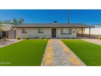 Charming single-story home featuring a well-manicured front yard with a paved walkway at 915 E Commonwealth Pl, Chandler, AZ 85225