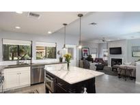 Bright, modern kitchen with marble island and stainless steel appliances open to the living space at 943 E Kortsen Rd # 10, Casa Grande, AZ 85122